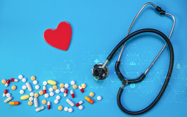 heart health concept with stethoscope and assorted medications on blue background depicting medical 