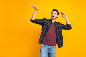 Wall Mural - Photo of nice guy crazy dancer inviting friends to dance floor wear casual plaid shirt isolated yellow color background