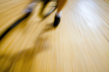 Blurred Motion of Cyclist on Wooden Gym Floor During Race