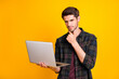 © deagreez - Photo of amazing guy with notebook in hands think over important business startup wear casual checkered shirt isolated yellow color background