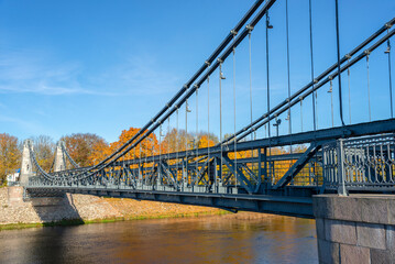 Wall Mural - Span of the old chain bridge. Velikaya River, Ostrov city, Pskov region, Russia