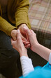 © AnnaStills - High angle shot of unrecognizable nurse holding hands of senior resident of nursing home