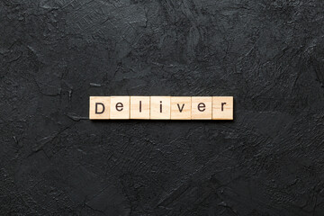 Wall Mural - deliver word written on wood block. deliver text on table, concept