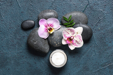 Wall Mural - Spa stones, cream and orchid flowers on dark background