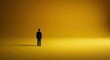 © Qstock - Solitary Businessman in a Vast Yellow Space, Minimalist Conceptual Photograph for Leadership and Contemplation Themes