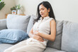 © KMPZZZ - Flatulence ulcer, asian young woman, girl hands in belly, stomach pain from food poisoning, abdominal pain and digestive problem, gastritis or diarrhea. Abdomen inflammation, menstrual period people.