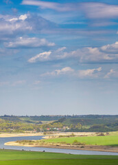 Wall Mural - beautiful landscape with a river and a green field