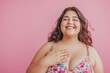 © Hunman - Beautiful loving obese woman touching her chest to her heart and feeling in love smiling.