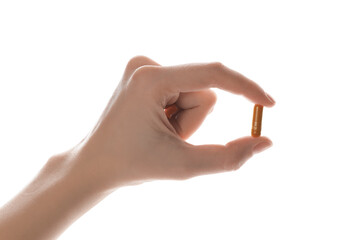 Wall Mural - Woman with turmeric capsule on white background, closeup