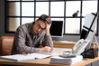 © Pixel-Shot - Worried male worker at table in office