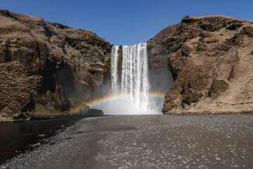 Iceland waterfall with a rainbow, mist and no people