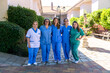 © Koldo_Studio - Group of nurses standing in nursing home courtyard