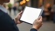 © 2April - Adult man uses tablet with blank white screen outdoors, Technology