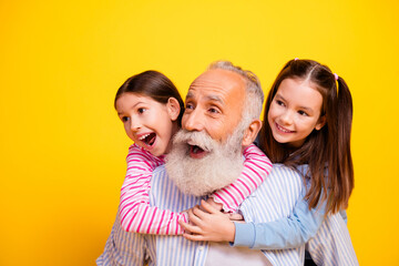 Poster - Happy grandfather with granddaughters enjoying a joyful moment together against yellow background