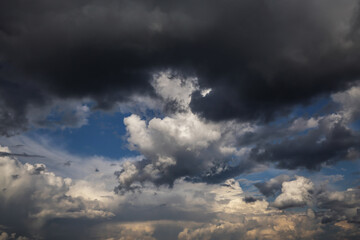 Wall Mural - Storm cloudy epic sky with dark rain grey black cumulus clouds, abstract background texture, thunderstorm, heaven