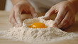 © Bonsales - Hands skillfully shape a flour nest on a wooden surface, cradling vibrant egg yolks. The scene captures a minimalist culinary moment, highlighting the art of baking preparation