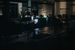 © qunica.com - A group of business coworkers collaborate late at night in a dimly lit office space, focusing on a project. The scene conveys teamwork, dedication, and a modern work environment.