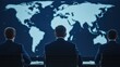 © Noppakun - Three suited figures facing a large digital map of the world, engaged in a serious discussion or analysis.