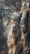 © NpicArt - Man standing on a rocky cliff overlooking a mountain range