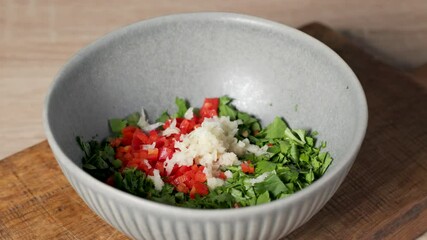 Canvas Print - chef add red wine vinegar into a bowl of parsley chili salad for making healthy vegan chimichurri sauce in home kitchen, food closeup