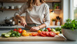 © Dmitry - Person Cutting Vegetables in a Bright Kitchen