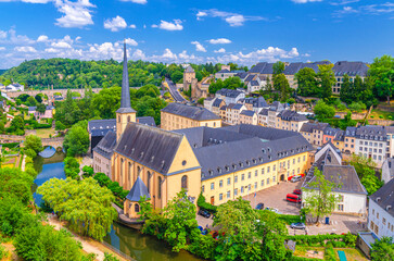 Wall Mural - Luxembourg City historical centre aerial view with Neimënster Abbey, Saint John's on the Stone catholic Church of Saint-Jean-du-Grund in river Alzette valley, Rham Plateau buildings in Grund district