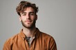 © J. Grayscale - Confident Young Man with Stylish Hair and Casual Attire Posing Against a Neutral Background