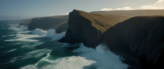 Wall Mural - An impressive scenic view of rugged coastlines down below where waves crash against cliffs creating a powerful dance of nature