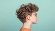 © musa - Teenager profile, curly hair, glasses, teal background, studio shot, fashion