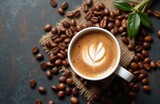 White lungo cup with hot coffee drink, coffee beans scattered on rustic black table. Top view. Latte art design. Excellent drink for moment of relaxation. Perfect for morning boost. Enjoyable