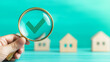 © bephoto - 不動産選定を示す木製模型とチェックマーク
