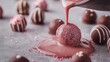 © Pixora Labs - Pink cream pouring on chocolate truffle balls