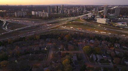 Wall Mural - Busy highway interchange of 401 and 404 in Ontario at sunset with city skyline view
