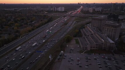 Wall Mural - Busy highway interchange of 401 and 404 in Ontario, Canada, at sunset with traffic flow
