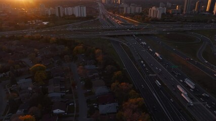 Wall Mural - Highway 401 and 404 in ontario at sunset with busy traffic flow, aerial view