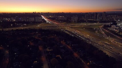 Wall Mural - Highway intersection in Ontario at sunset, vibrant lights, aerial city view