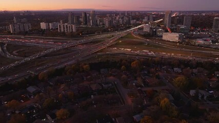Wall Mural - Ontario’s 401 and 404 highways at dusk with city lights and traffic, aerial view