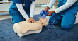 © AchillesReel25/peopleimages.com - Mask, medical or nurses learning cpr on mannequin for first aid, help cardiac arrest or safety protocol. Healthcare class, hands or people with respiratory tool in paramedic course or nursing school