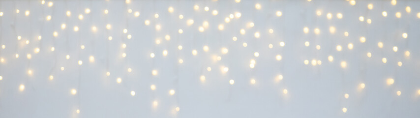Wall Mural - Christmas light decoration blurred festive gold bokeh light on white background