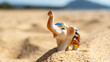 © I - Elephant figurine on a sandy beach by the sea, travel and recreation concept