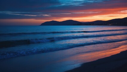 Wall Mural - serene coastal sunset with deep blue and orange hues reflecting over calm ocean waves and silhouette