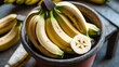 © AkuAku - Fresh Bananas Displayed in a Rustic Pot with a Sliced Banana on a Wooden Table for Culinary or Tropical Themes