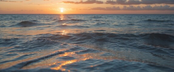 Wall Mural - Atlantic Ocean sunset close-up showcasing shimmering water textures and warm hues reflecting the golden light of the setting sun.