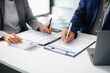 © laddawan - Business People Talking Discussing with financial document data charts and graphs Team business meeting