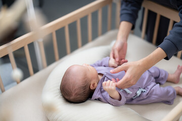 Wall Mural - Mother holds her baby  hand gently