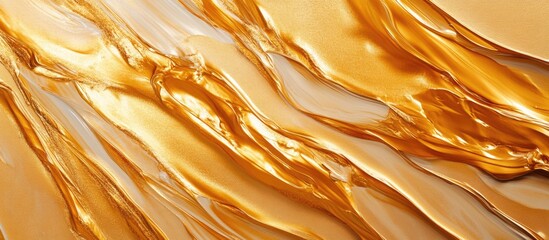 Wall Mural - Gold paint texture with flowing abstract patterns creating a visually striking and elegant background for artistic or design applications.