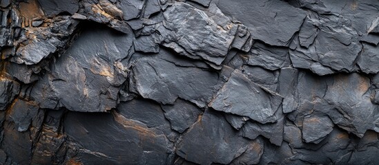 Wall Mural - Textured black slate surface background with layered stone appearance for design and decorative purposes.