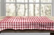 © artwiyanastudio - Wooden table with red checkered tablecloth by window