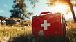 © Anthichada - A red first aid kit at an outdoor, Emergency medical supplies, Medical responders in outdoor emergency scenarios