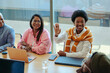 © Jacob Lund - Creative agency meeting highlighting a person raising a hand to contribute innovative ideas